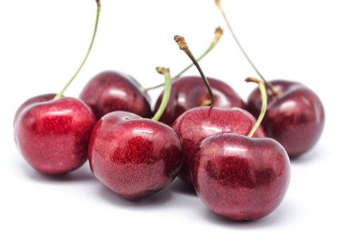 macro photograph of some cherries on white background